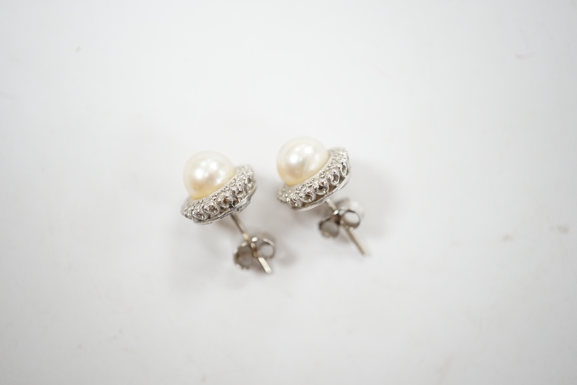 A pair of white metal cultured pearl and diamond cluster set ear studs, 10mm, gross weight 3.6 grams. Condition - fair to good